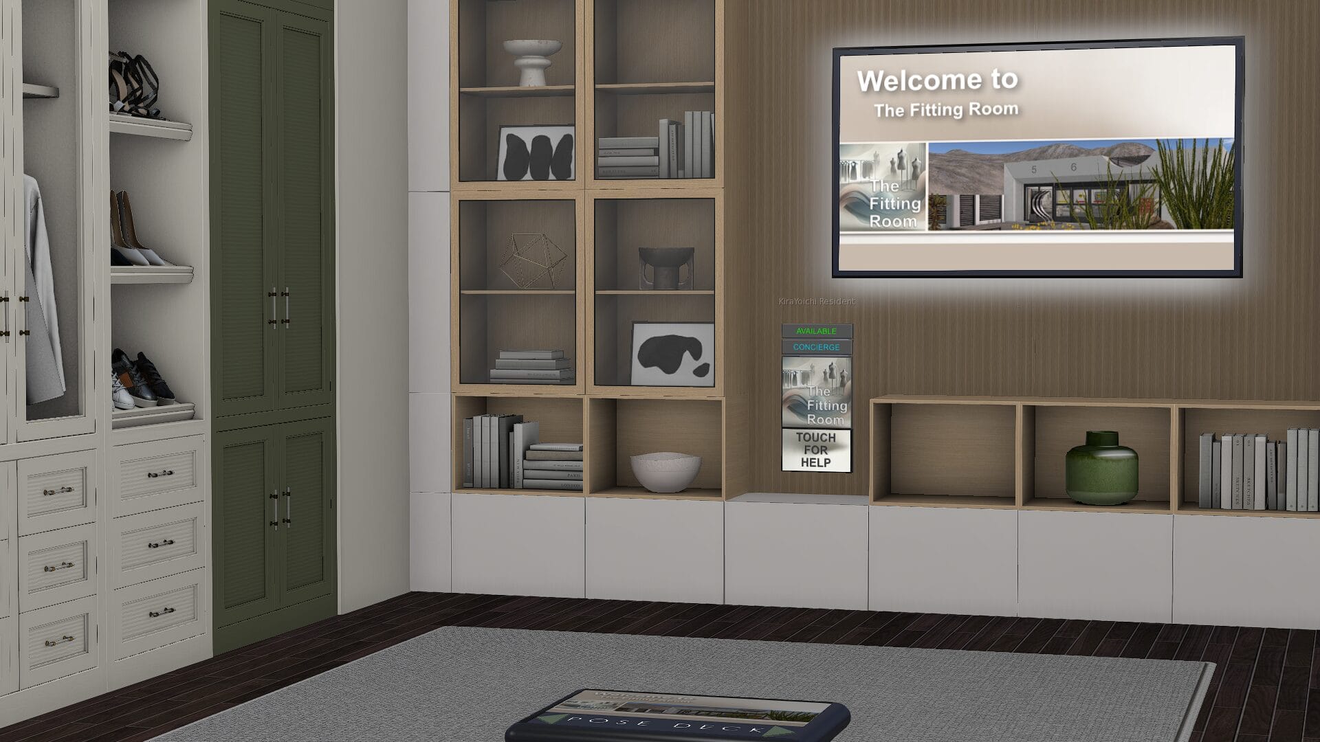 Interior of The Fitting Room showing a styled dressing room with floor-to-ceiling open shelving in natural wood and white, stacked books and decorative objects, a dark green wardrobe, white drawer units with shoes displayed on shelves, dark hardwood flooring, a grey area rug, and a wall-mounted screen displaying The Fitting Room welcome banner. A concierge panel with a "Touch for Help" button is visible on the wall.